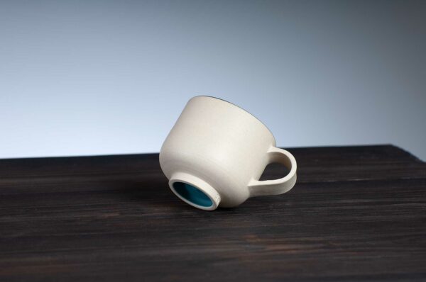 bottom view of espresso cup with teal rim