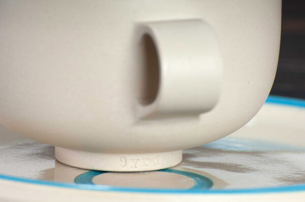 detail view of cappuccino cup and saucer set with blue rim