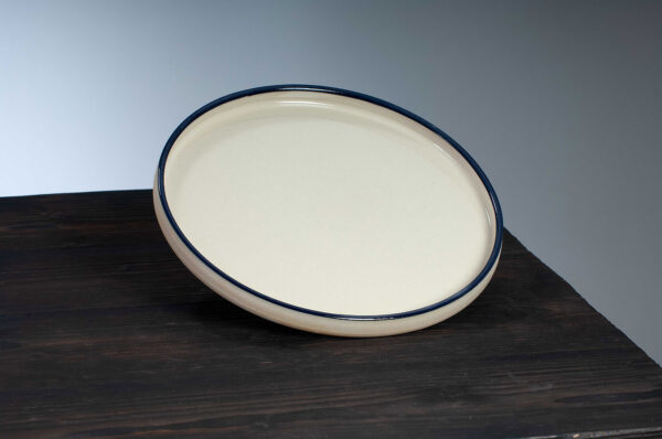 top view of dinner plate with navy rim