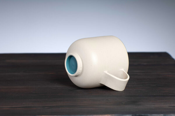 bottom view of stoneware mug with teal rim