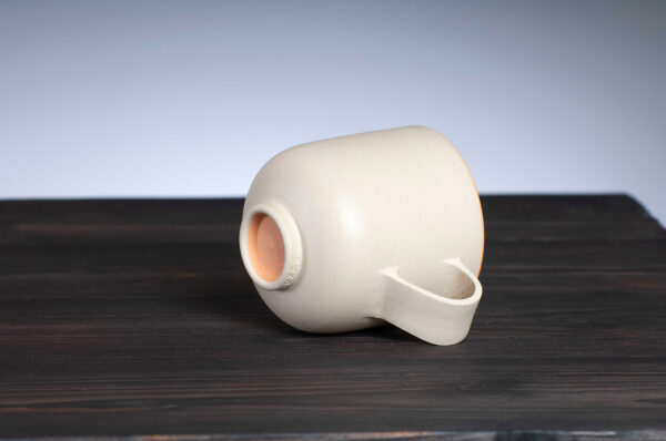 bottom view of stoneware mug with orange rim