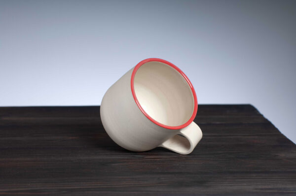 top view of stoneware mug with red rim